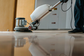 worker cleaning floor with machine