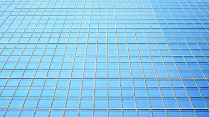 Blue sky and clouds reflected in windows of modern office building. Modern glass facade. 