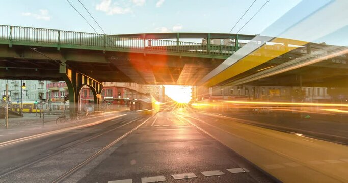 Early morning Time lapse at busy street in central Berlin, trams, cars and trains moving on a busy intersection in 4k