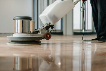 worker cleaning floor with machine