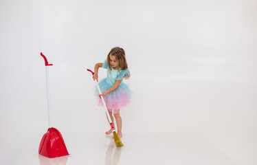 a blonde girl in a festive dress does the cleaning on a white background with a place for text