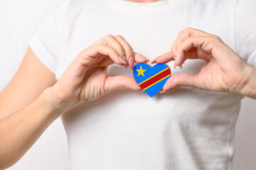 Flag of Democratic Republic of Congo in the shape of a heart in the hands of a girl. Love Congo....