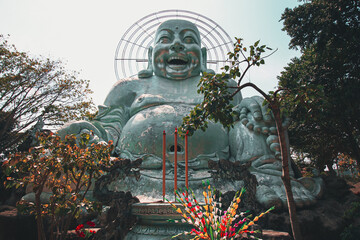 Low angle view of a giant Smiling Buddha Statue in Linh An Pagoda in Da lat, Vietnam - Powered by Adobe