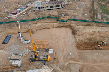 Truck crane during the installation of a tower crane at construction site. Construction Foundation...
