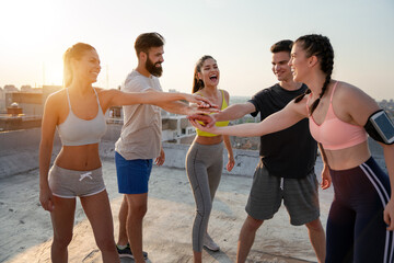 Group of fit healthy friends, people exercising together outdoor