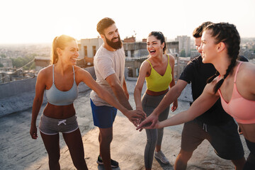 Fitness, sport, training and lifestyle concept. Group of fit people exercising outdoor