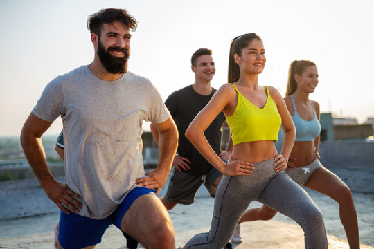 Group Of Happy Friends Working Out Together Outdoors. Fitness, Training, Sport And People Concept