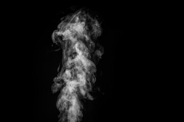 Perfect mystical curly white steam or smoke isolated on black background. Abstract background fog or smog, design element, layout for collages.