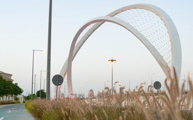 Doha, Qatar - May 26, 2021: Al Wahda Bridge in doha city. known as 5/6 Bridge of Arch.Doha, Qatar -...