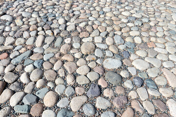 the pavement is made of boulders. cobblestone pavement 