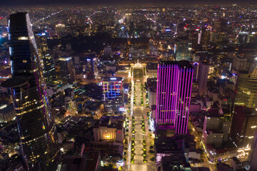 Fototapeta na wymiar Ho Chi Minh City skyline and the Saigon River. Amazing colorful night view of skyscraper and other modern buildings at downtown. Ho Chi Minh City is a popular tourist destination of Vietnam.