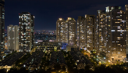 Obraz premium Ho Chi Minh City skyline and the Saigon River. Amazing colorful night view of skyscraper and other modern buildings at downtown. Ho Chi Minh City is a popular tourist destination of Vietnam.