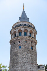 Fototapeta premium Famous tourist place Galata tower seems between old traditional buildings. Empty street, no people. Istanbul during coronavirus lockdown.