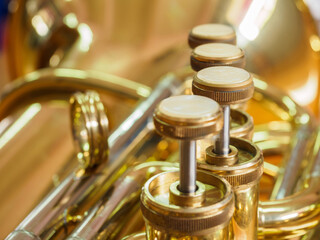 close-up shot of piston value tuba, brass instrument piston value 