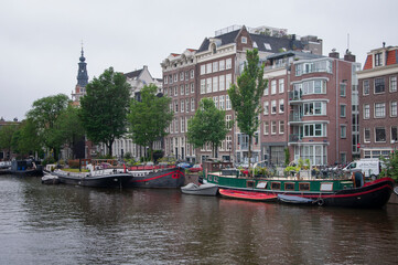 AMSTERDAM, NETHERLANDS. JUNE 06, 2021. Beautiful view of Amsterdam with typical dutch houses, bridges and chanel.