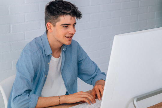 young teenage student at desk working at computer