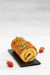 A sweet floss roll cake with topping  spicy chicken meat and beef floss 