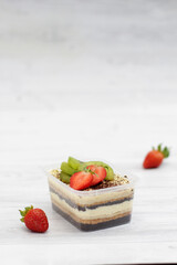 A slice of sweet Tiramisu mousse cake with cheese, chocolate, whip cream and cookies crumble