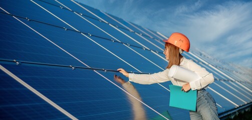 Businesswomen working on checking equipment at solar power plant with tablet checklist, woman...