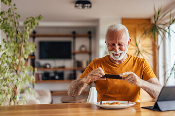 Senior man, working on his recipe book.