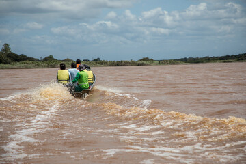 Men sailing on the boat in indigenous territory flooded by the Rio Doce, in the state of Espírito...