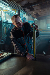 Fototapeta premium The handyman measuring the bar in the workshop
