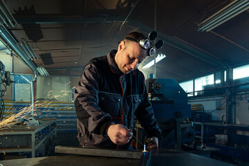 Welder working with autogenous welding tool in workshop