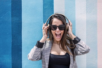 Excited woman listening to music and screaming