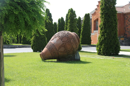 Old ceramics wine jars called kvevri at the wine factory in Georgia. Traditional ceramic pottery barrel for wine.
