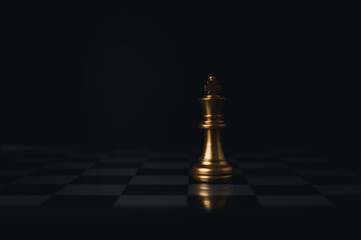 Gold king winner surrounded with silver chess pieces on chess board game competition.concept...