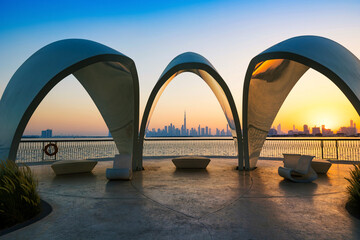 A beautiful view of Dubai city skyline in the evening with a colorful sky. A view from Dubai Creek harbour.