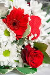 Flower bouquet close-up. A bouquet of flowers is collected by a florist from different flowers, a flower arrangement. Photo with a small depth of field, defocus. 