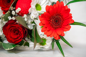 Flower bouquet close-up. A bouquet of flowers is collected by a florist from different flowers, a flower arrangement. Photo with a small depth of field, defocus. 