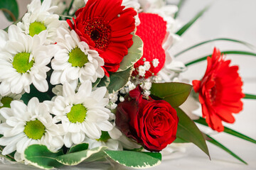 Flower bouquet close-up. A bouquet of flowers is collected by a florist from different flowers, a flower arrangement. Photo with a small depth of field, defocus. 