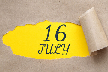 july 16. 16th day of the month, calendar date.Hole in paper with edges torn off. Yellow background is visible through ragged hole.Summer month, day of the year concept