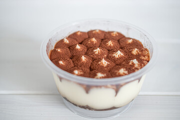 purchased tiramisu cake on white background