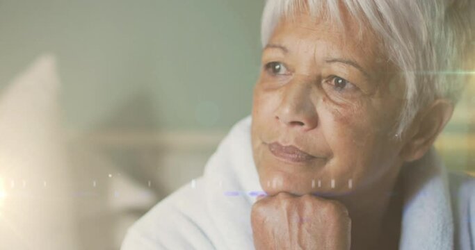 Animation of glowing lights over thoughtful senior woman in background