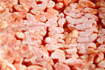 Frozen red minced meat close up, background.