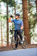 Fototapeta premium Cyclist drinking water during a riding break