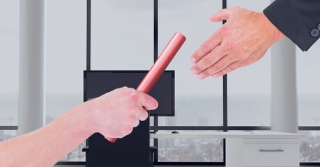 Composition of two people passing red relay baton over empty office in background