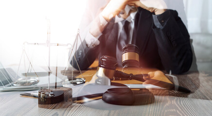 Business and lawyers discussing contract papers with brass scale on desk in office. Law, legal services, advice, justice and law concept picture with film grain effect