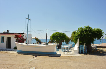 Rhodes Island, Kiotari small greek restaurant with sea view and a old boat