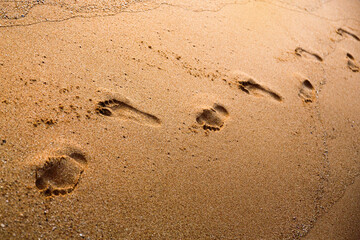 Footprints on sand beach at morning