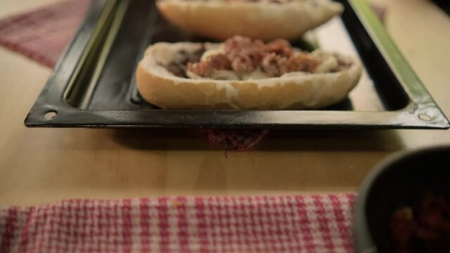 Three traditional Mexican molletes on a black tray