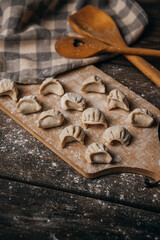 Frozen, beautifully sculpted dumplings laid out on a cutting board