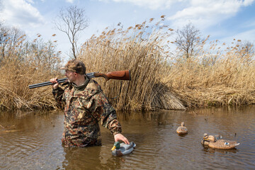 hunter walks on water with tied plastic dummy ducks