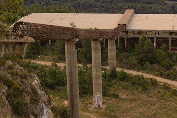 Fototapeta na wymiar Kilometre-long conveyor belt for transporting stones from the quarry to the plant