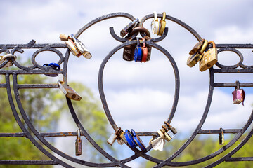 lovers' castles attached to the fence of the bridge