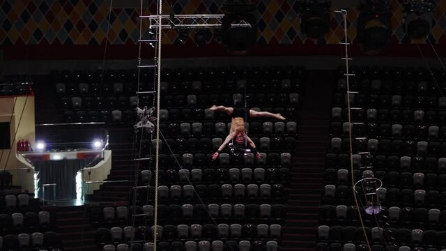 Training in empty circus - a man spinning around in the air