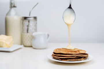 Sour cream or Condensed Milk pouring pancake on bag.
